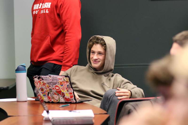 a man sitting at a table with a laptop