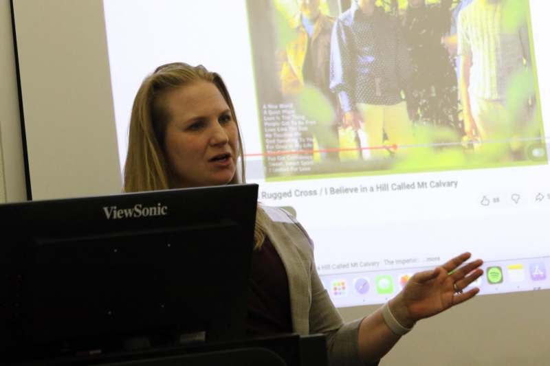 a woman standing in front of a screen