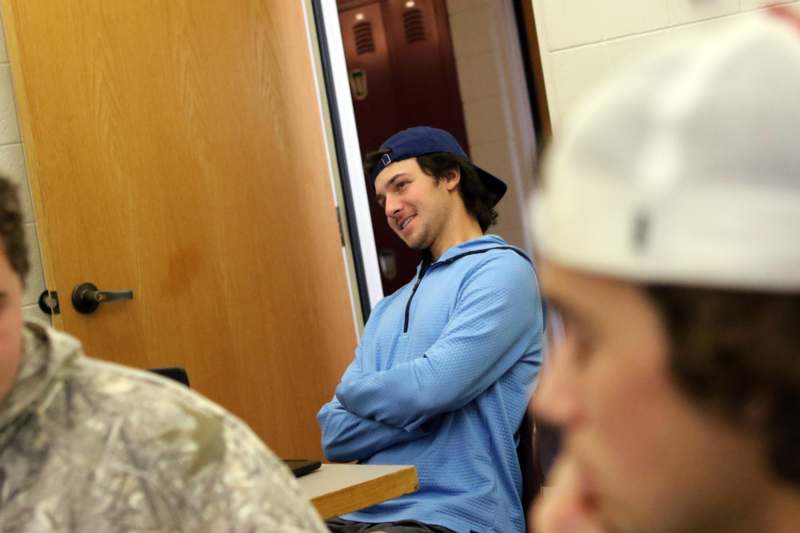 a man in a blue shirt with his arms crossed