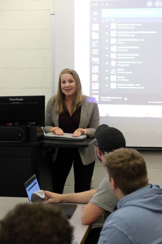 a woman standing in front of a screen