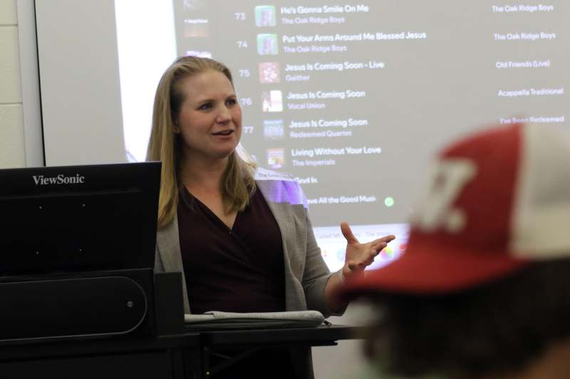 a woman standing in front of a screen