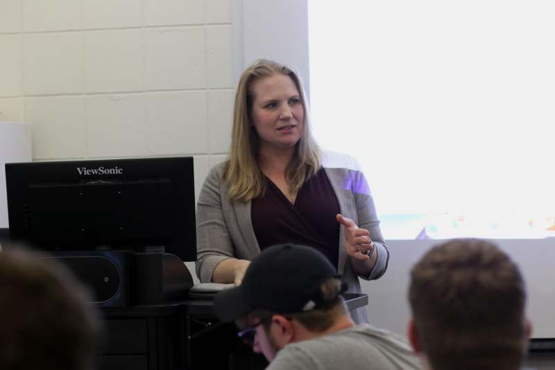 a woman standing in front of a group of people