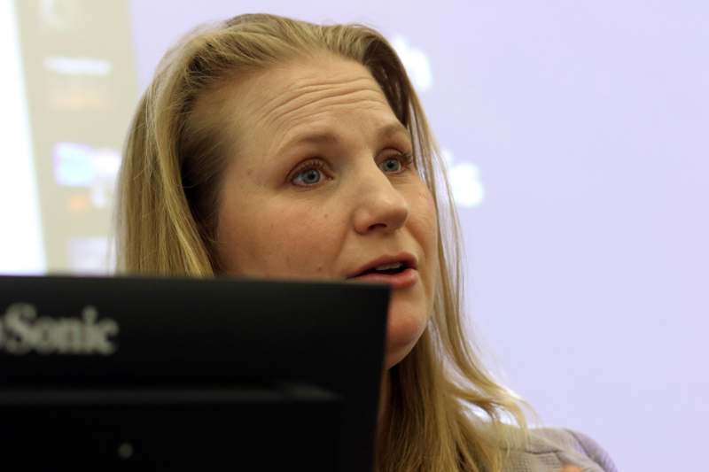 a woman looking at a computer screen