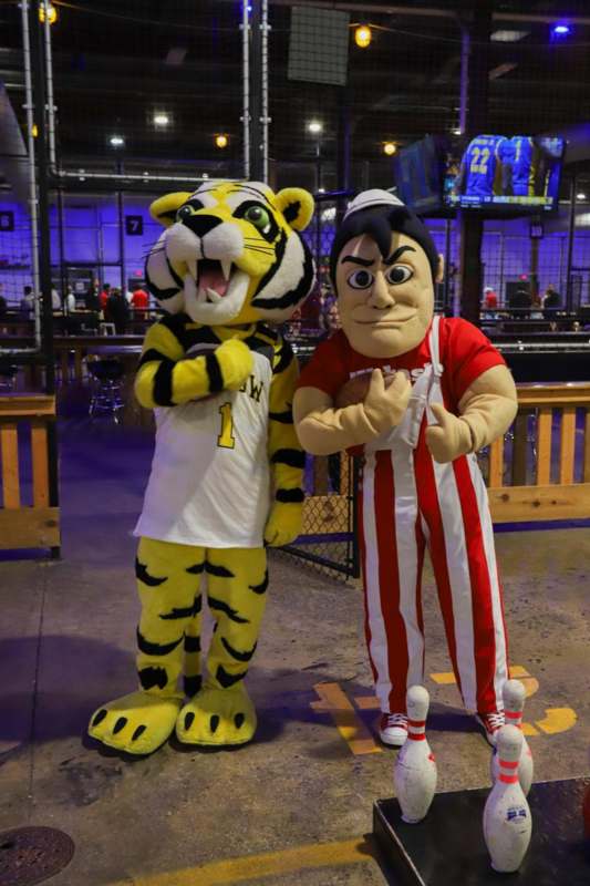 two people in clothing standing next to each other