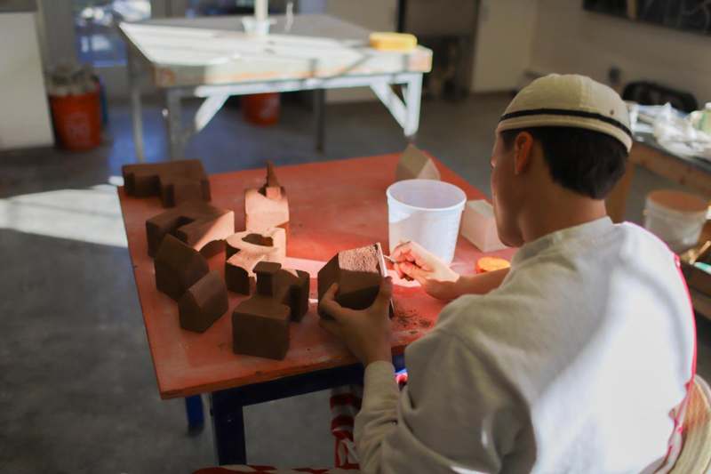 a man working on a clay model