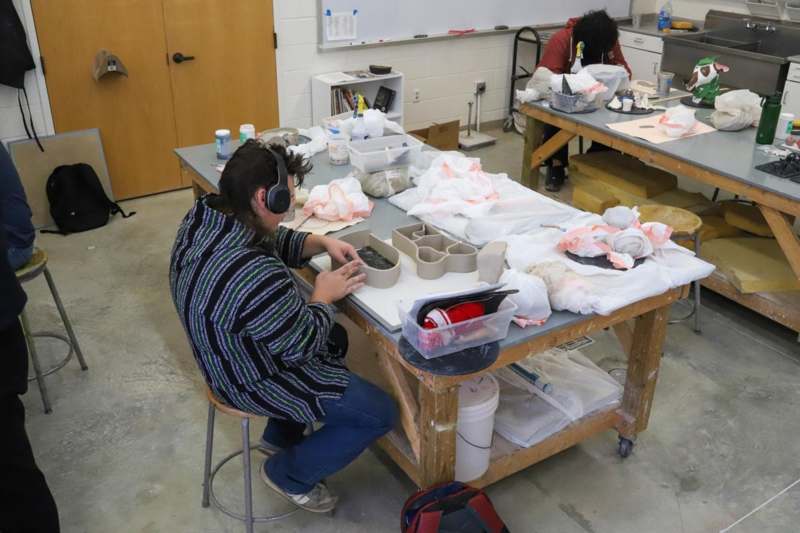 a man sitting at a table with objects on it