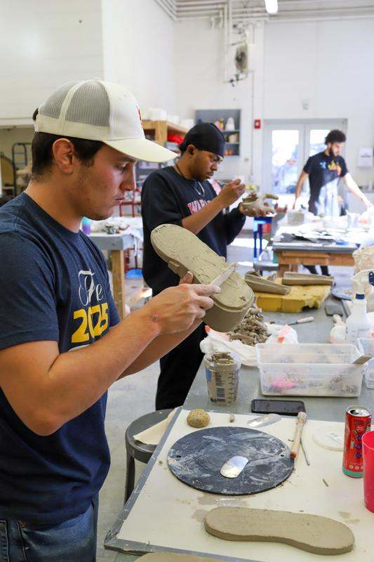 a group of men working on clay