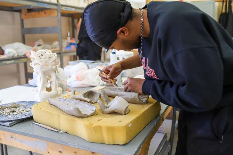 a man working on a sculpture