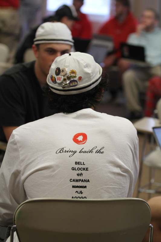 a person wearing a white hat with patches on their back