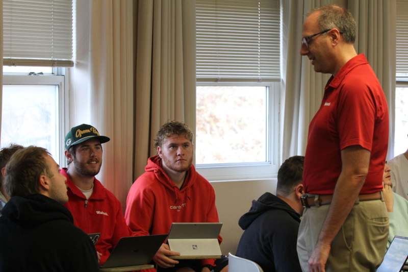 a group of men in red shirts