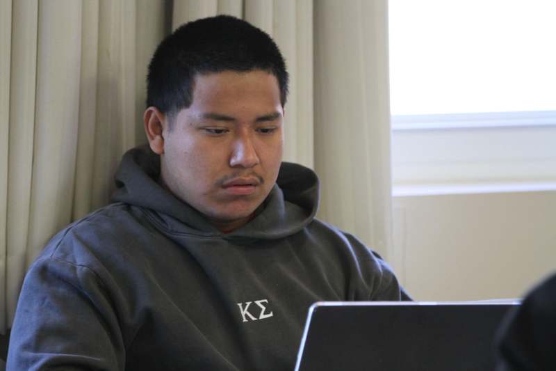 a man looking at a laptop