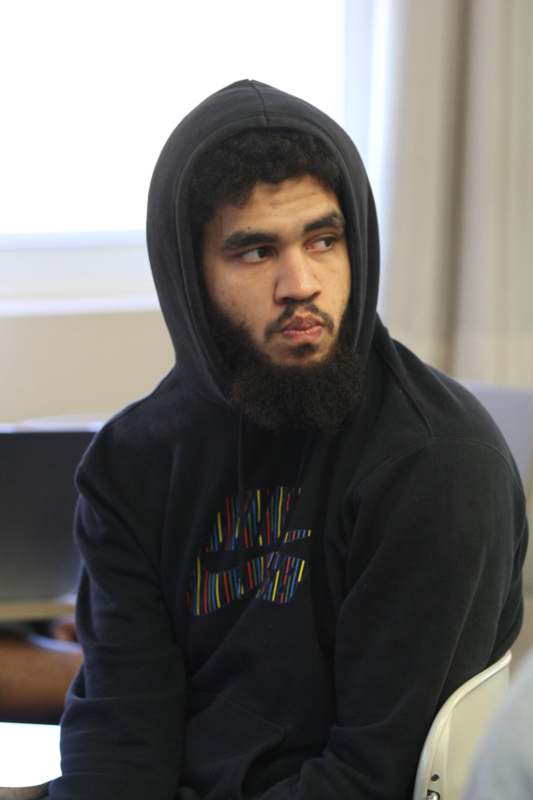 a man wearing a black hoodie