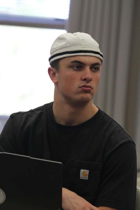 a man wearing a white hat