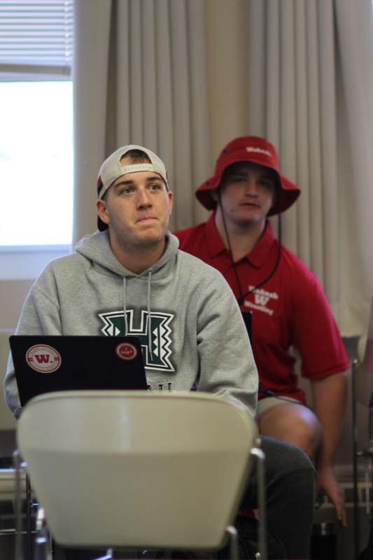 a group of men sitting in a room