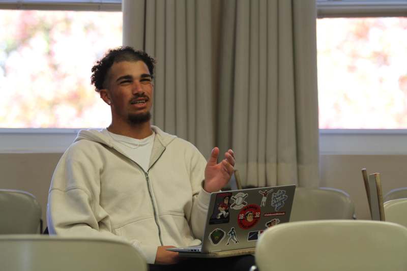 a man sitting in a chair with a laptop