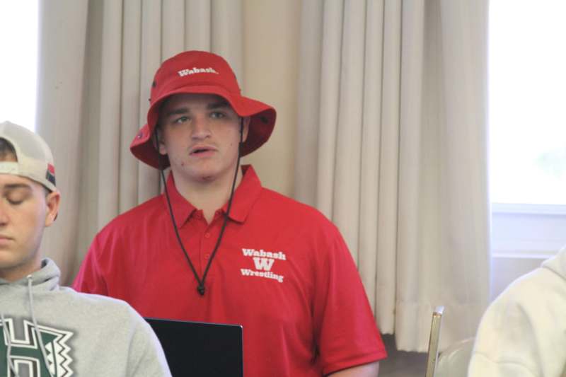 a man wearing a red shirt and a hat