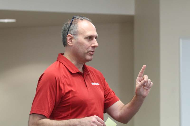 a man in a red shirt pointing his finger