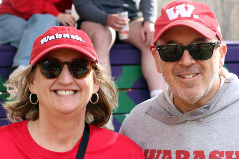 a man and woman wearing red hats and sunglasses
