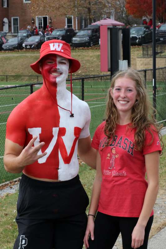 a man with a body paint and a woman posing for the camera