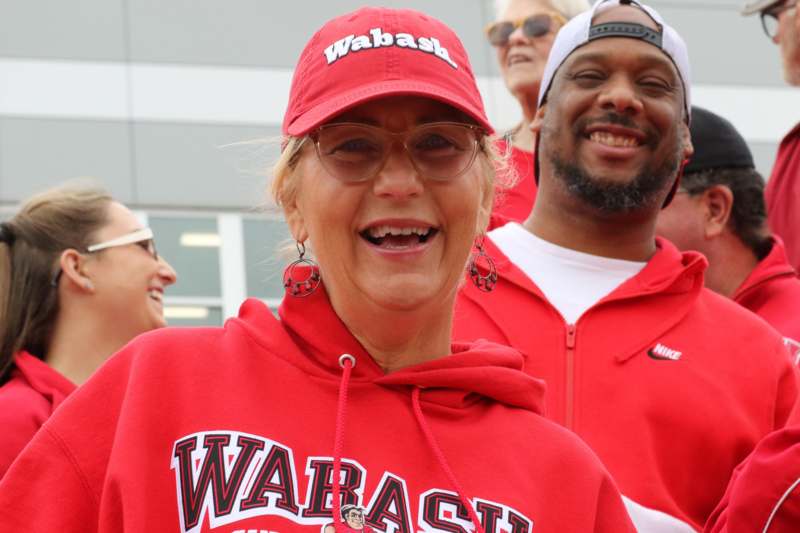a woman wearing a red hat and glasses smiling
