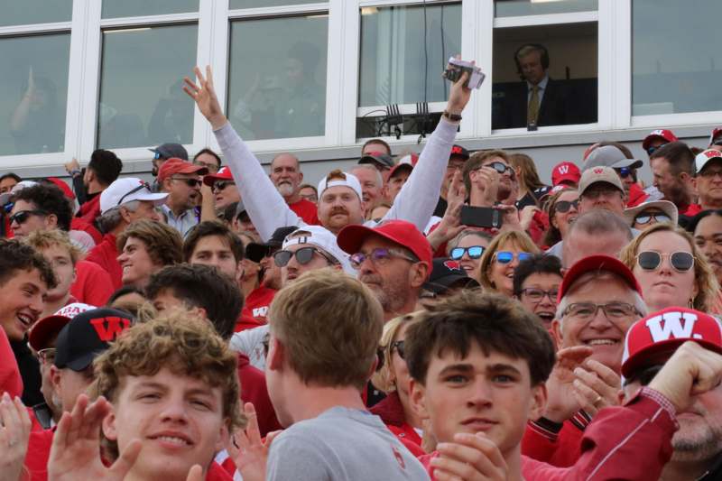 a group of people in red shirts