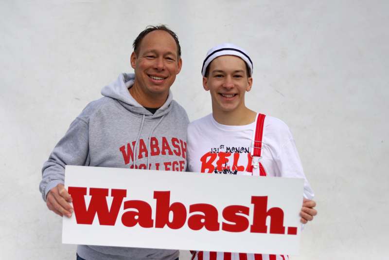 a man and boy holding a sign