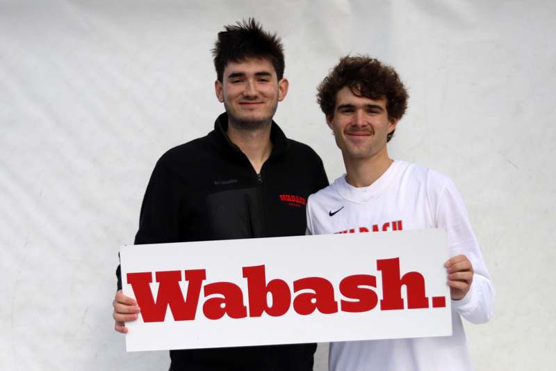 two men holding a sign