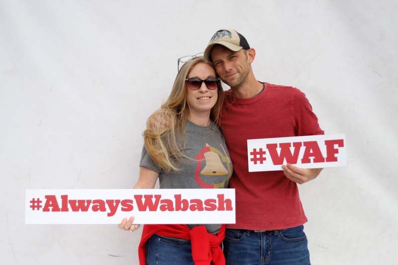 a man and woman holding signs