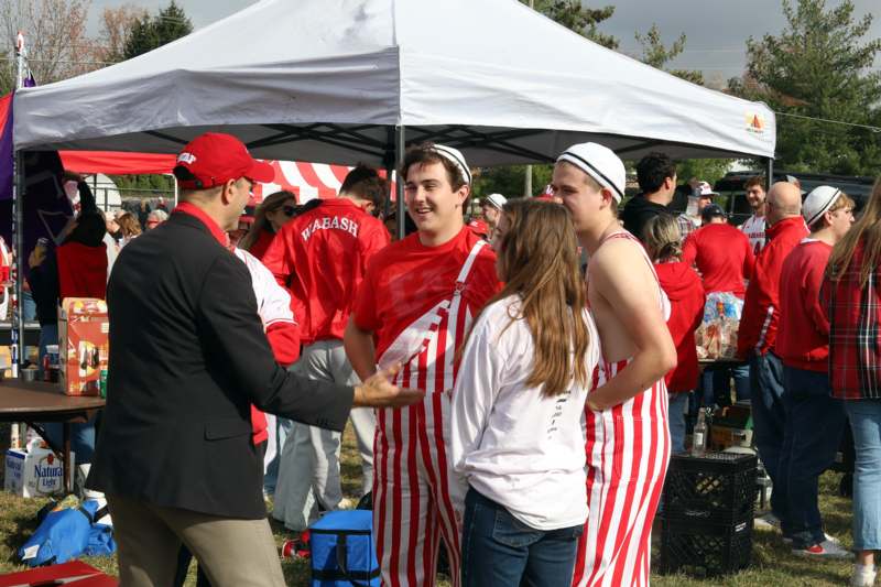a group of people standing under a tent