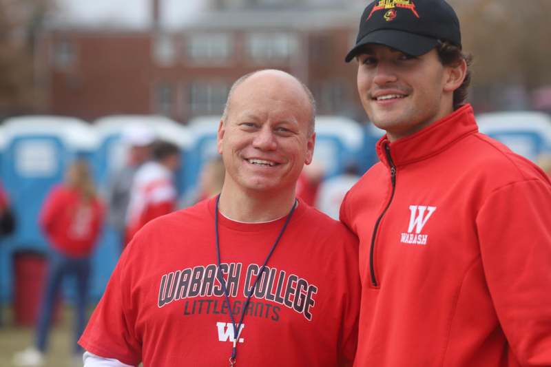 two men standing together smiling