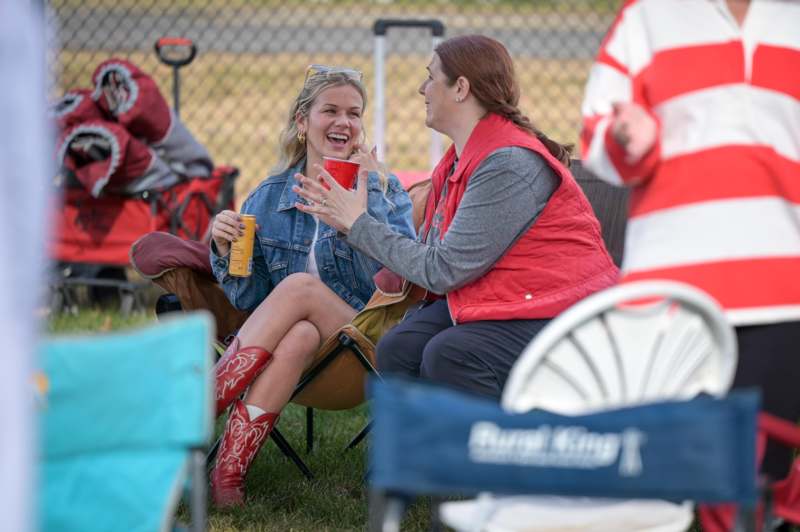 a group of women sitting in chairs and drinking