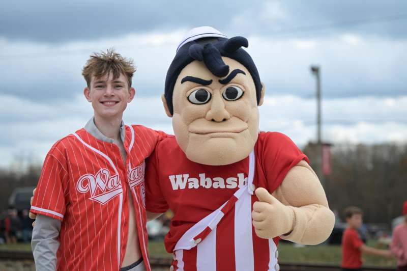 a man standing next to a person in a mascot garment