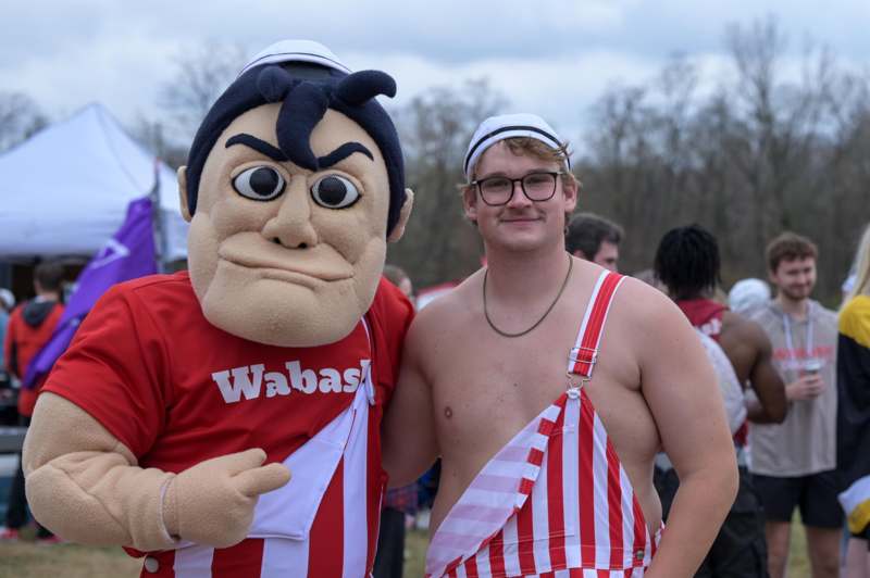 a man standing next to a person in a garment