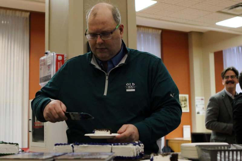 a man cutting a cake