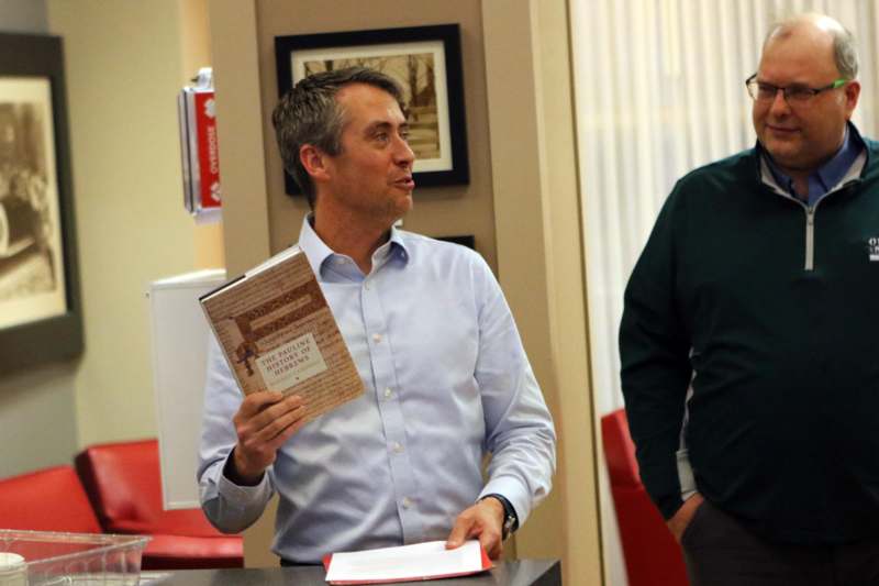 a man holding a book