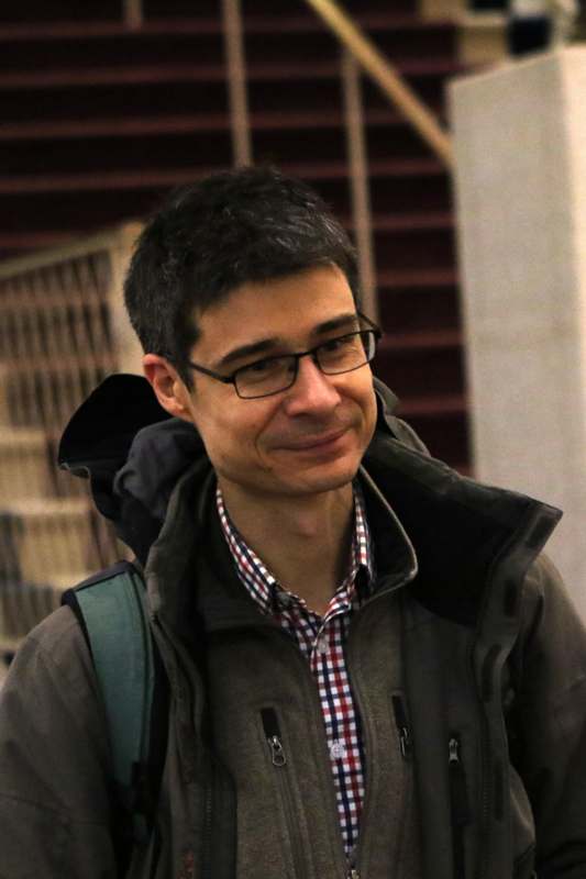 a man wearing glasses and a backpack