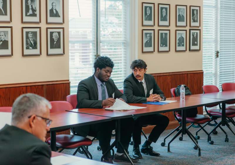 a group of men sitting at a table