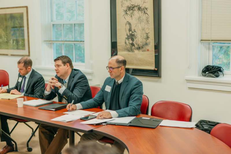 a group of men sitting at a table