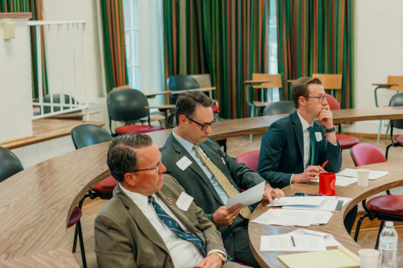 a group of men sitting at a round table