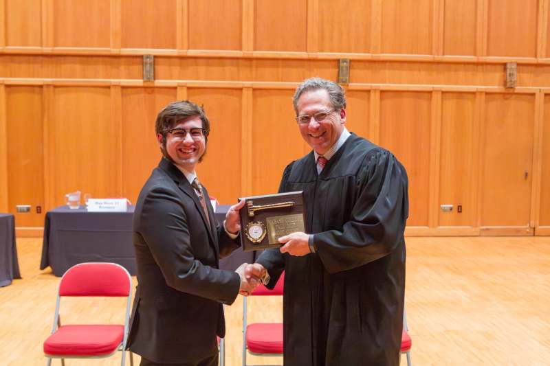 a man shaking hands with a judge
