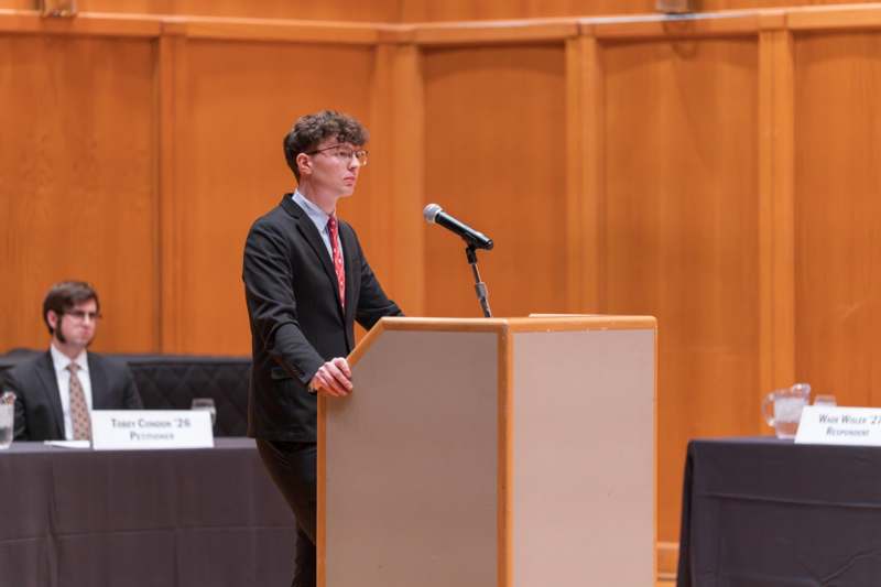 a man standing at a podium with a microphone
