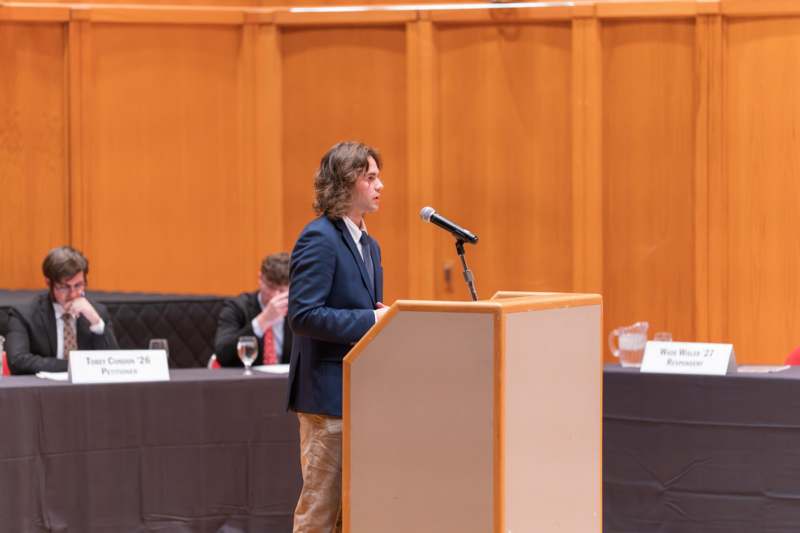 a man standing at a podium with a microphone