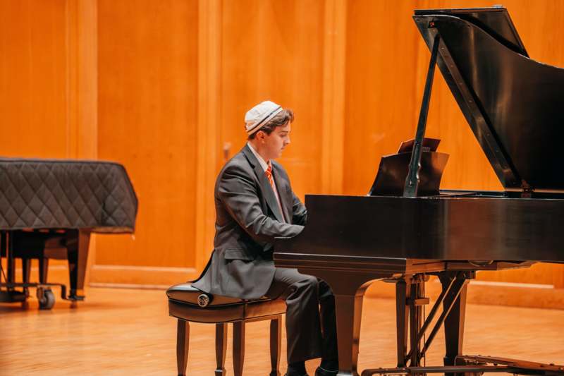 Student Music Recital (11/11/25) - a man playing a piano