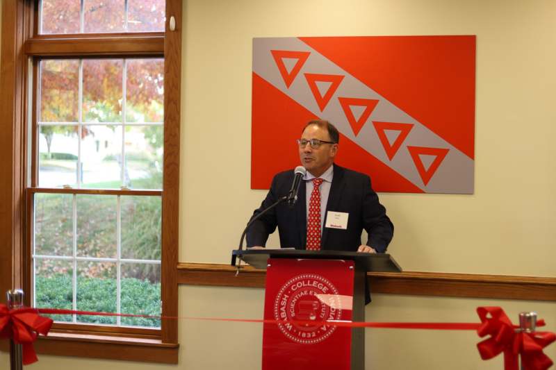 a man standing at a podium with a microphone