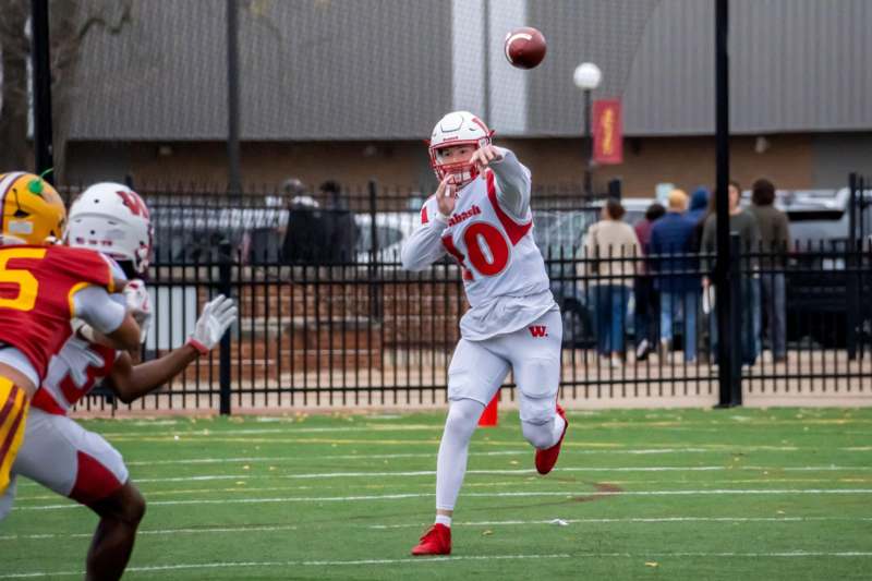 a football player throwing a football