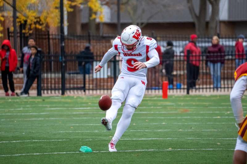 a football player kicking a football