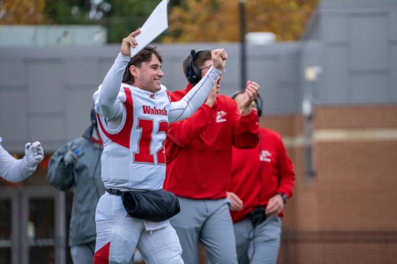 a football player holding a paper and cheering