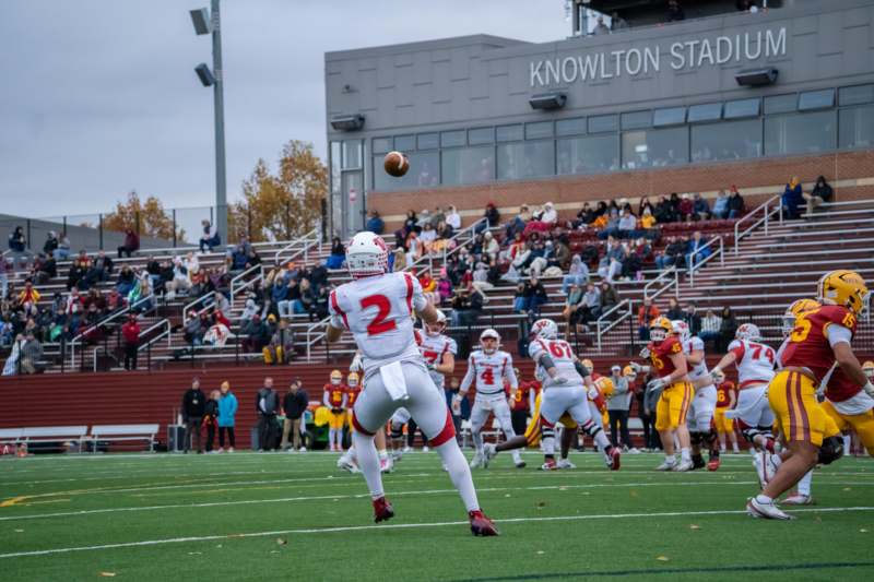 a football player throwing a football