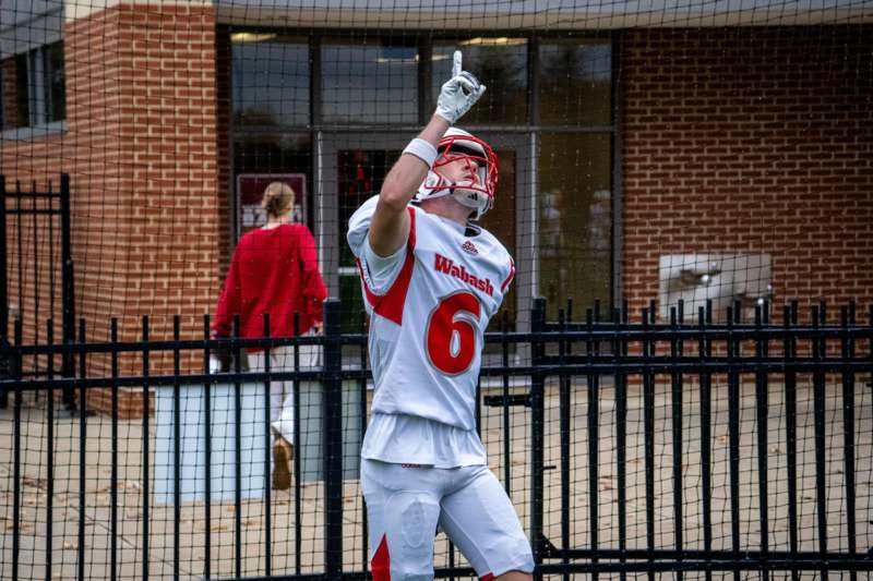 a man wearing a football uniform pointing up