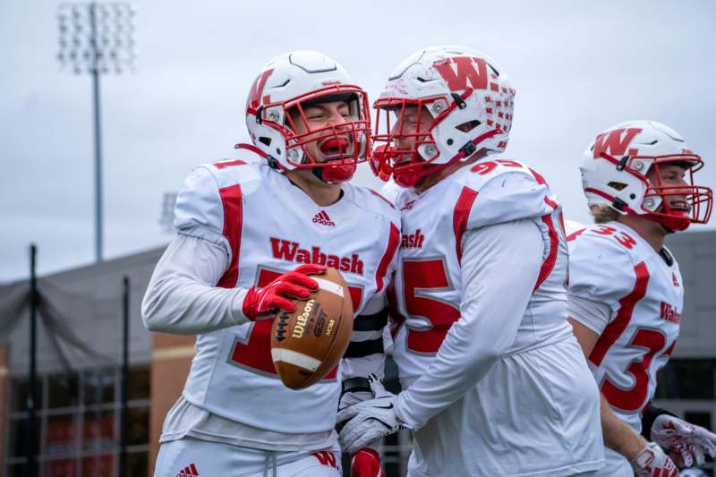a group of football players in white and red uniforms